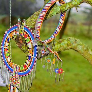 Handcrafted Maasai beaded bridal jewellery set by Kisieku including beaded crown, hanging neckpiece, bracelets and earrings in vibrant traditional African patterns, made in Kenya for Moransbead