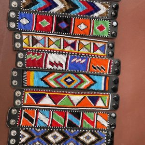 Handcrafted Maasai beaded leather bracelet by Nalaakiti featuring vibrant colourful traditional African seed bead patterns on a genuine leather base with secure closure, made in Kenya for Moransbead