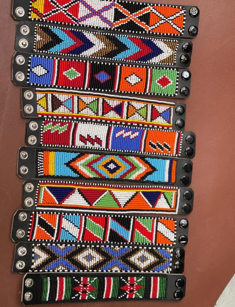 Handcrafted Maasai beaded leather bracelet by Nalaakiti featuring vibrant colourful traditional African seed bead patterns on a genuine leather base with secure closure, made in Kenya for Moransbead