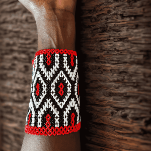 Handcrafted Maasai beaded wide cuff bracelet by Sianto featuring vibrant colourful traditional African seed bead patterns, made in Kenya for Moransbead