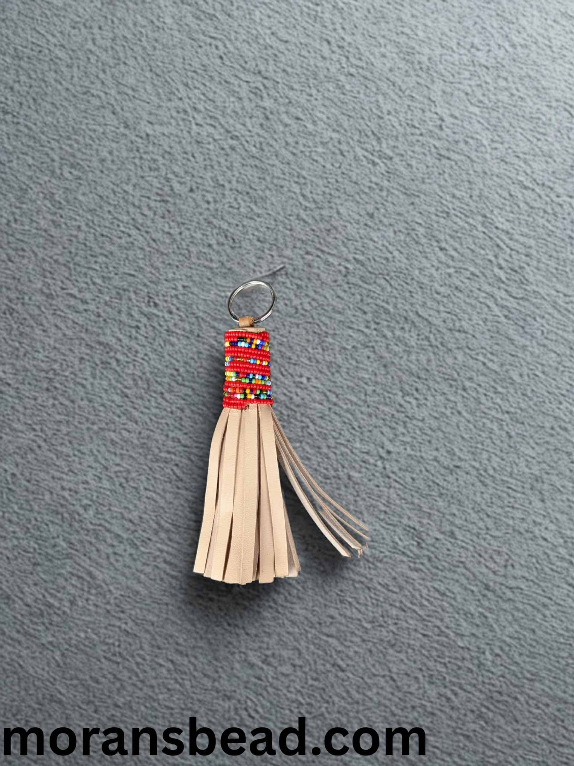 Beaded leather keychain crafted by Maasai artisans, featuring vibrant colors and traditional African.