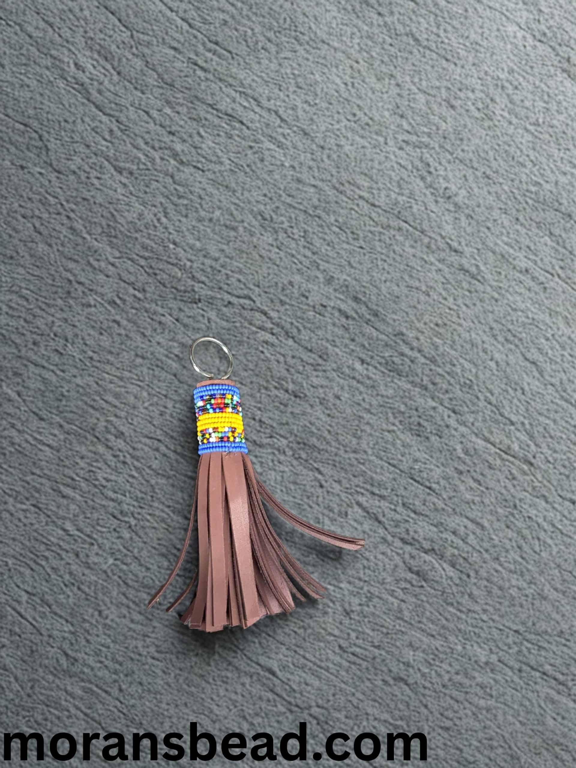 Beaded leather keychain crafted by Maasai artisans, featuring colorful traditional beadwork and genu.
