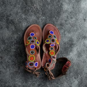 Vibrant Maasai beaded leather sandals with intricate patterns and bright colors, showcasing traditio.