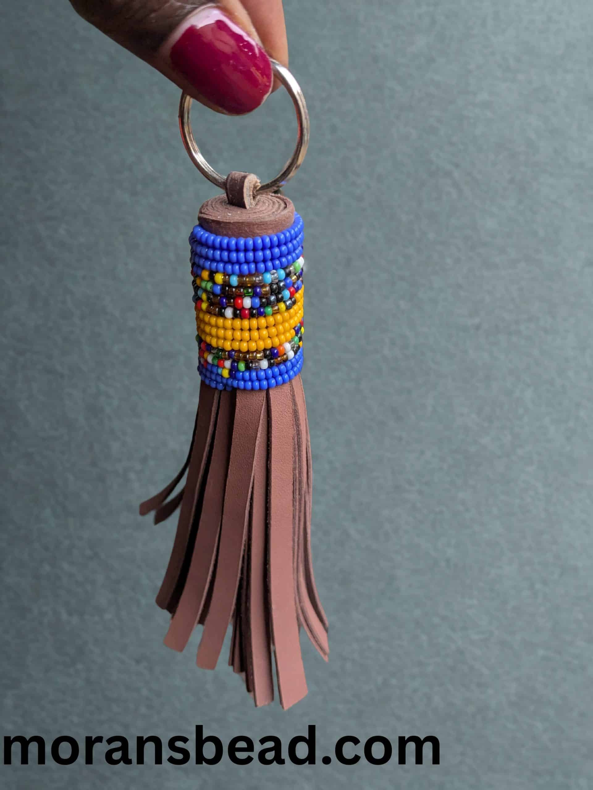 Beaded leather keychain crafted by Maasai artisans, featuring vibrant colors and traditional African.
