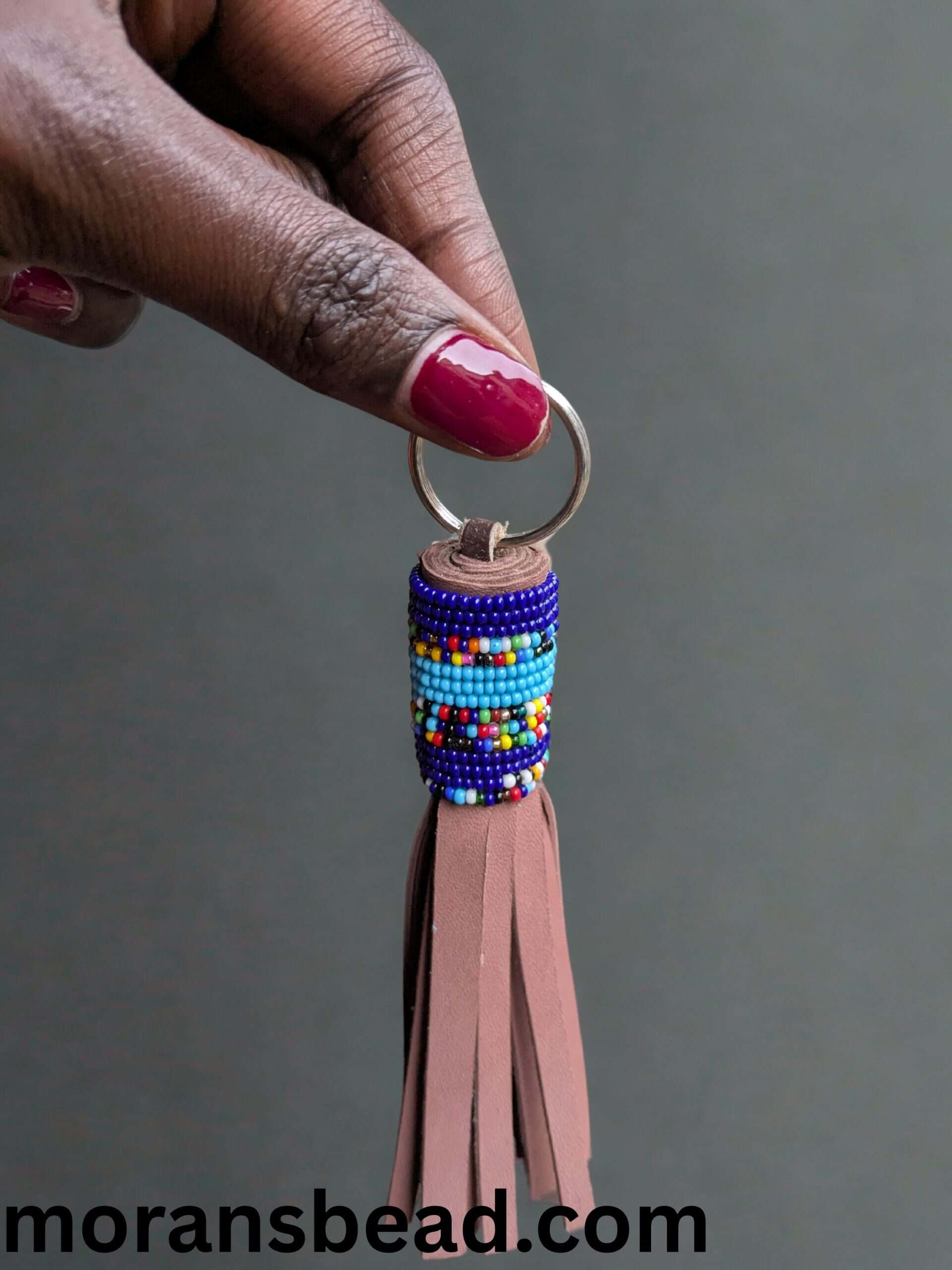 Handcrafted Maasai beaded leather keychain with vibrant colors and traditional African design.