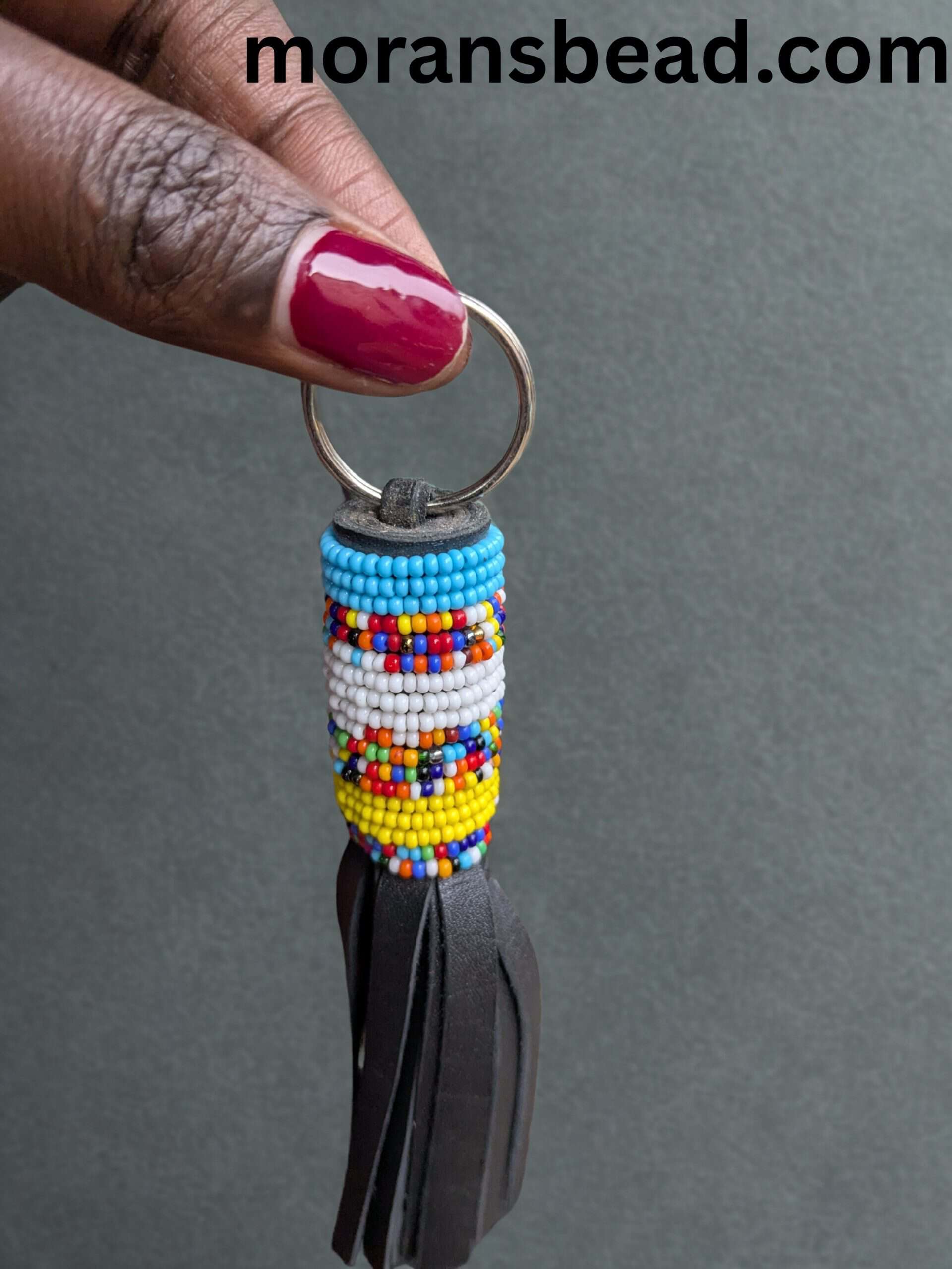 Beaded leather keychain crafted by Maasai artisans, featuring vibrant colors and traditional African.
