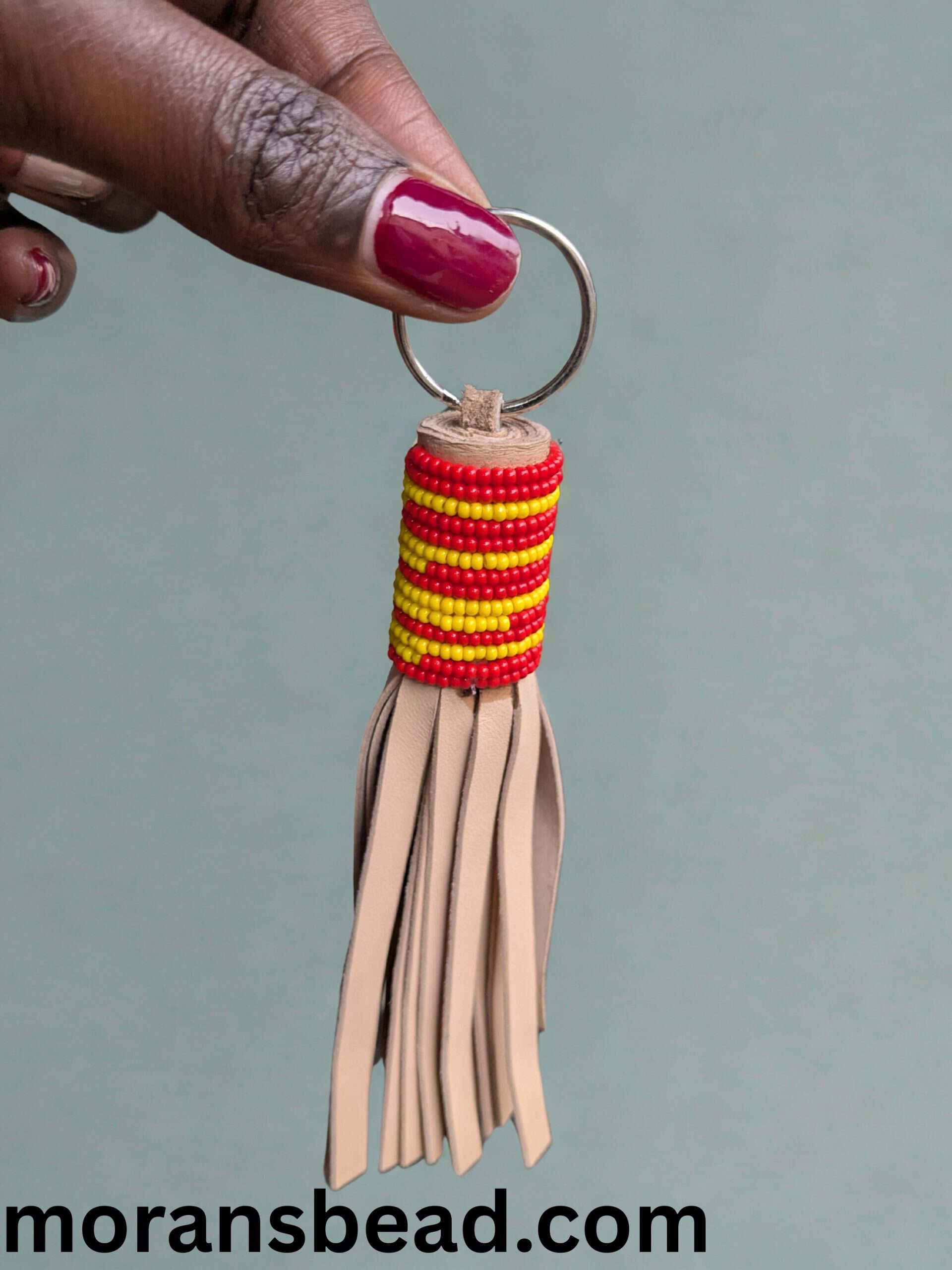 Colorful Maasai beaded leather keychain with fringe detail.