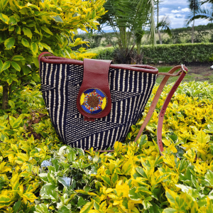 Spacious handcrafted Maasai beaded leather and sisal handbag by Naiswaku, featuring woven sisal body, genuine leather handles and trim, and colourful hand-beaded Maasai detail, made in Kenya for Moransbead